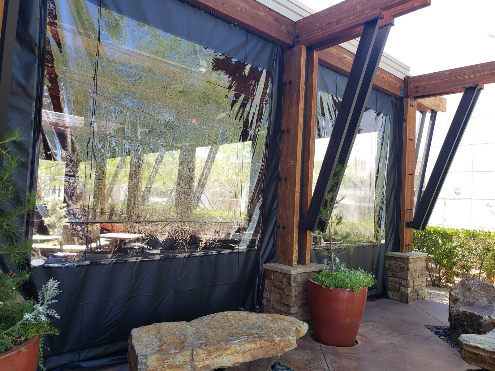 Corner of the patio showing panel edges sealed to the timber posts