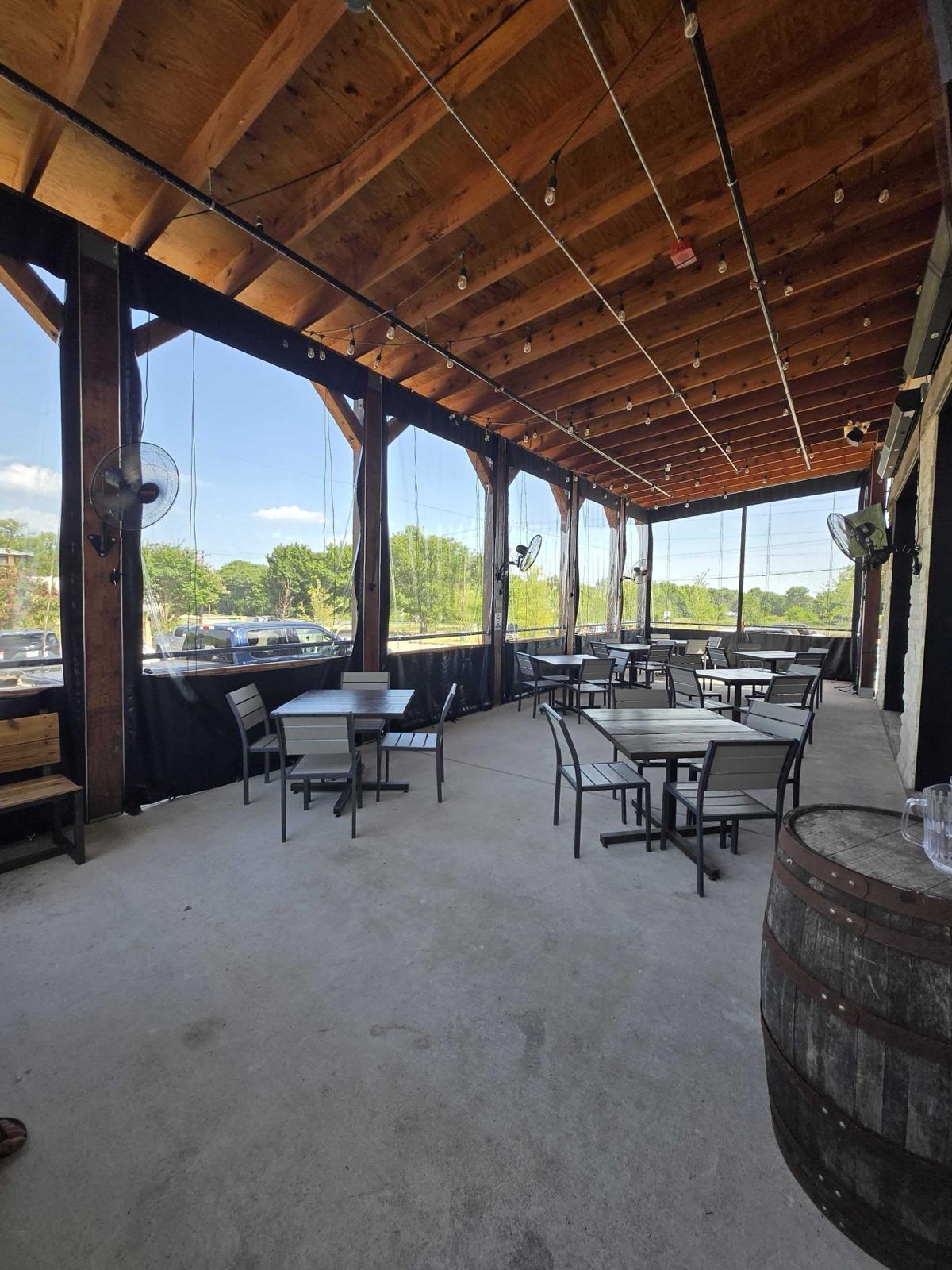Manual roll clear panels down around a restaurant patio under a timber roof