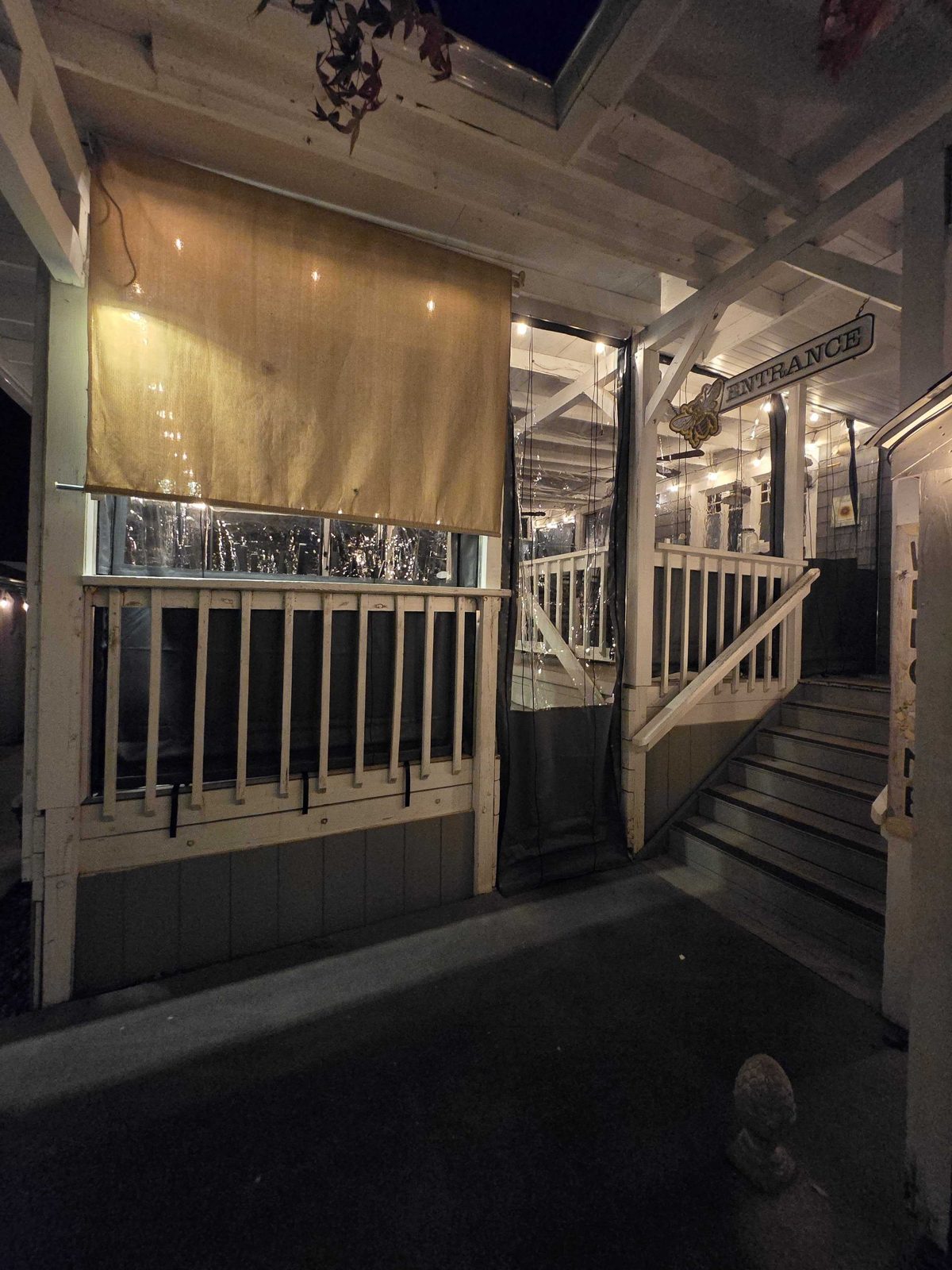 Grey trimmed clear vinyl panels along the porch