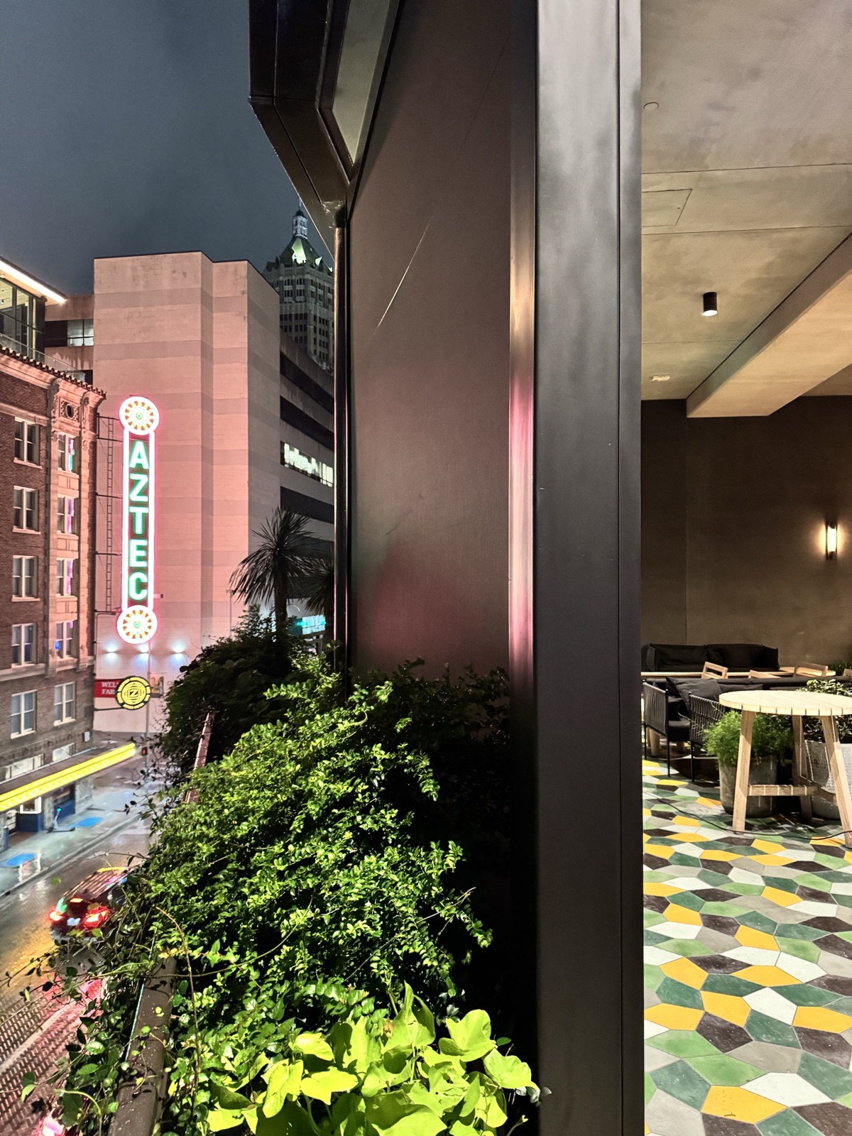 The rooftop patio at night with the curtains down and the San Antonio skyline behind