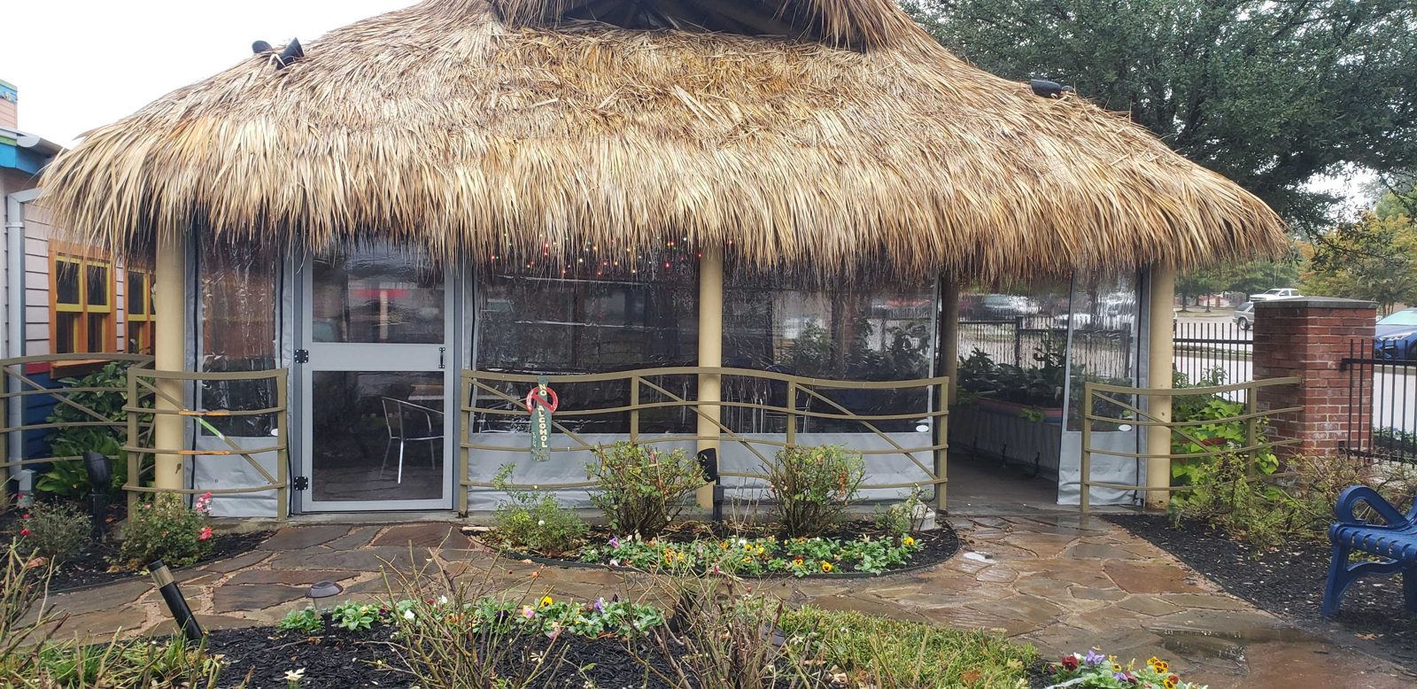 Chuy's Tyler: the palapa patio closed in clear panels with gray borders, the flagstone path to the door