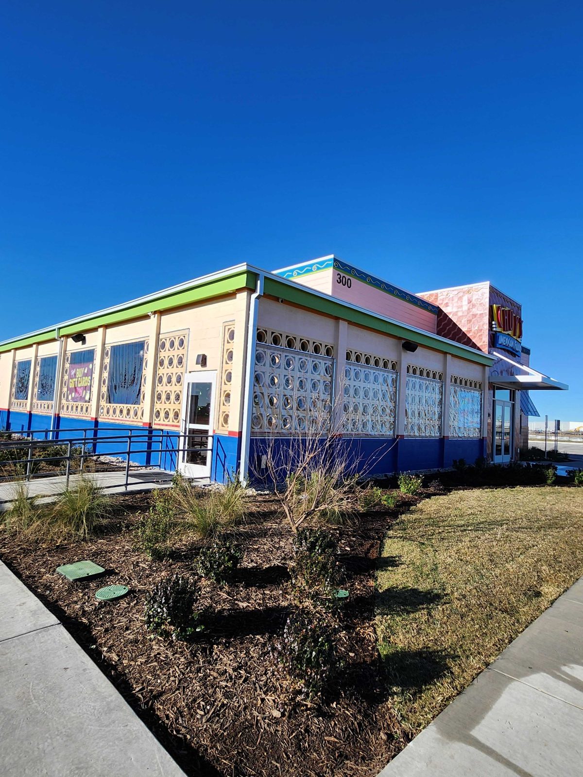 Chuy's Terrell: fixed clear panels behind the breeze-block wall of the new prototype, the blue base and lime trim
