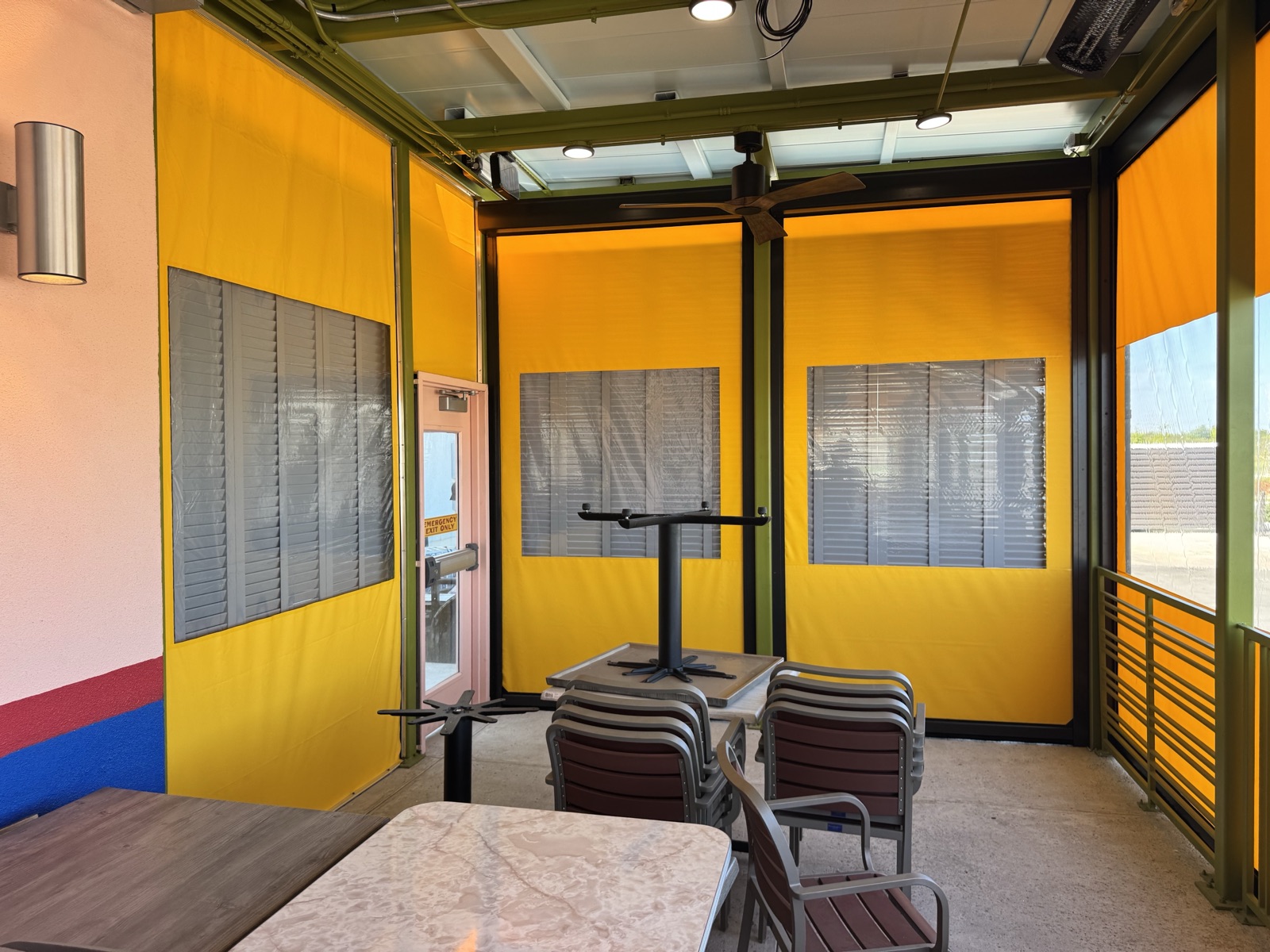 Inside the enclosed patio: clear windows at eye level, yellow vinyl above and below