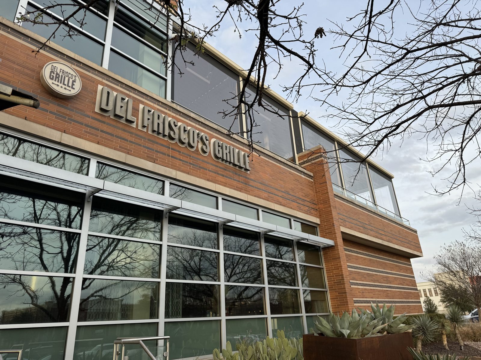 Del Frisco's Southlake from the street: the second-floor terrace closed in screens above the Grille sign