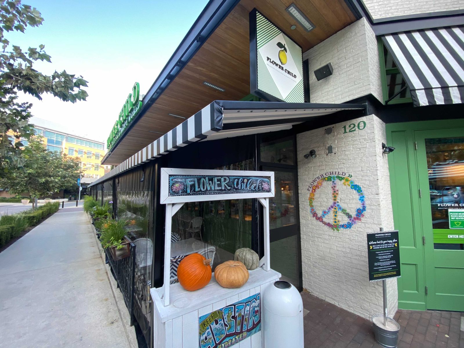 The entry with the lemon sign and the pumpkin cart, the clear panels running down the sidewalk side