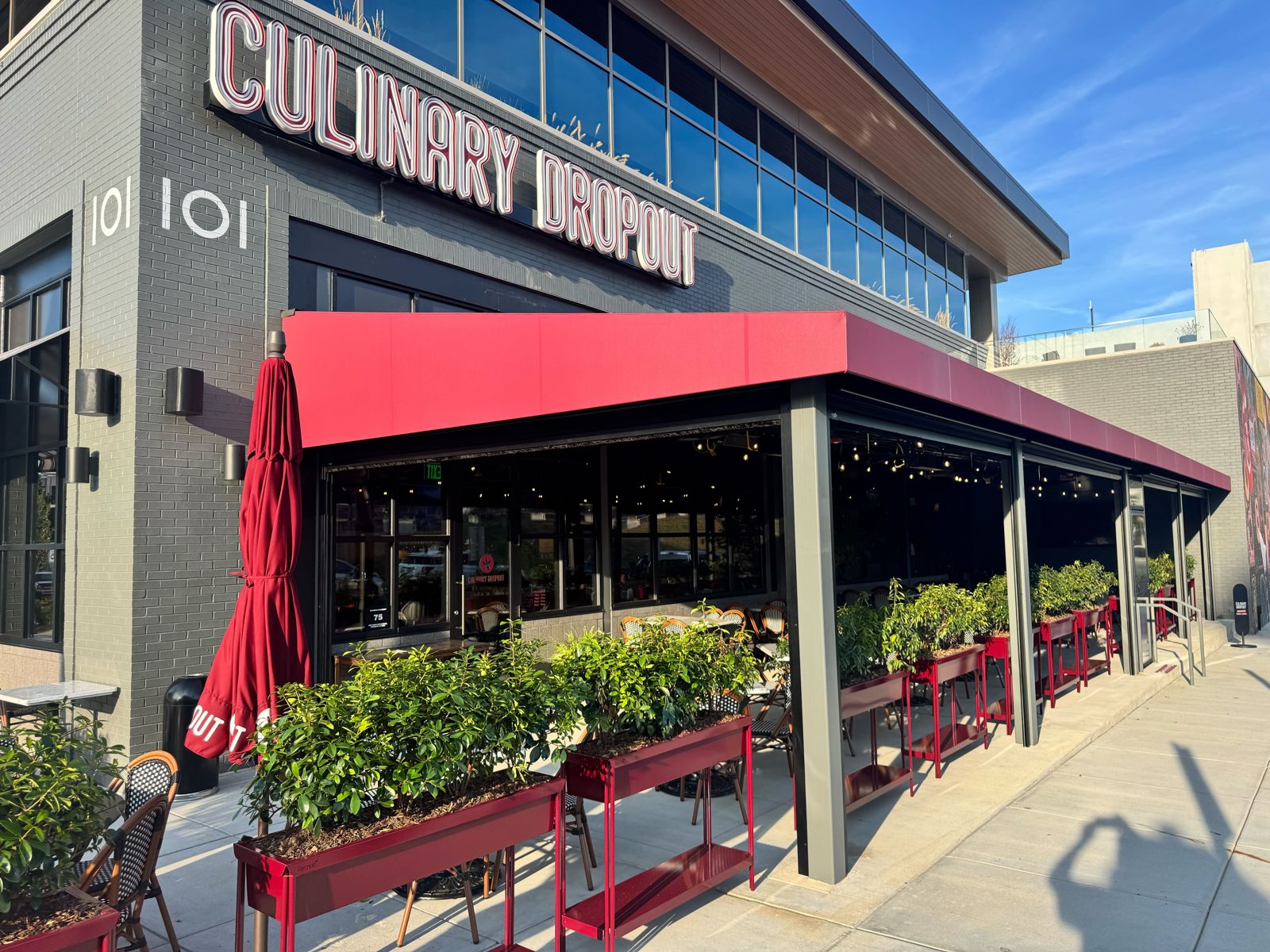 Culinary Dropout Franklin, Tennessee: the patio under the red awning closed in motorized screens, the neon above