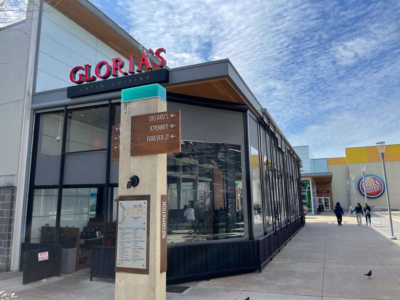 Gloria's Baybrook from the mall walk: the screens down along the patio with the restaurant lit inside