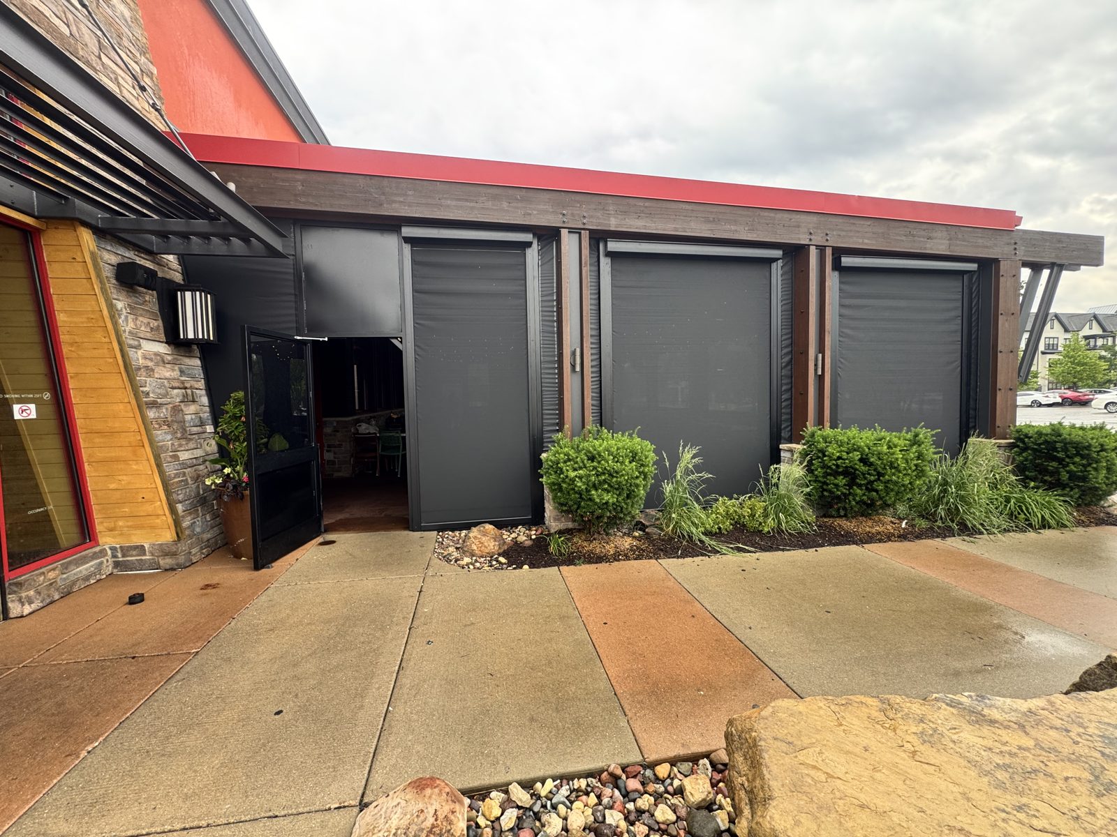 Lazy Dog Vernon Hills, Illinois, June 2026: the first motorized Lazy Dog patio, black screens in the housings between the timber posts