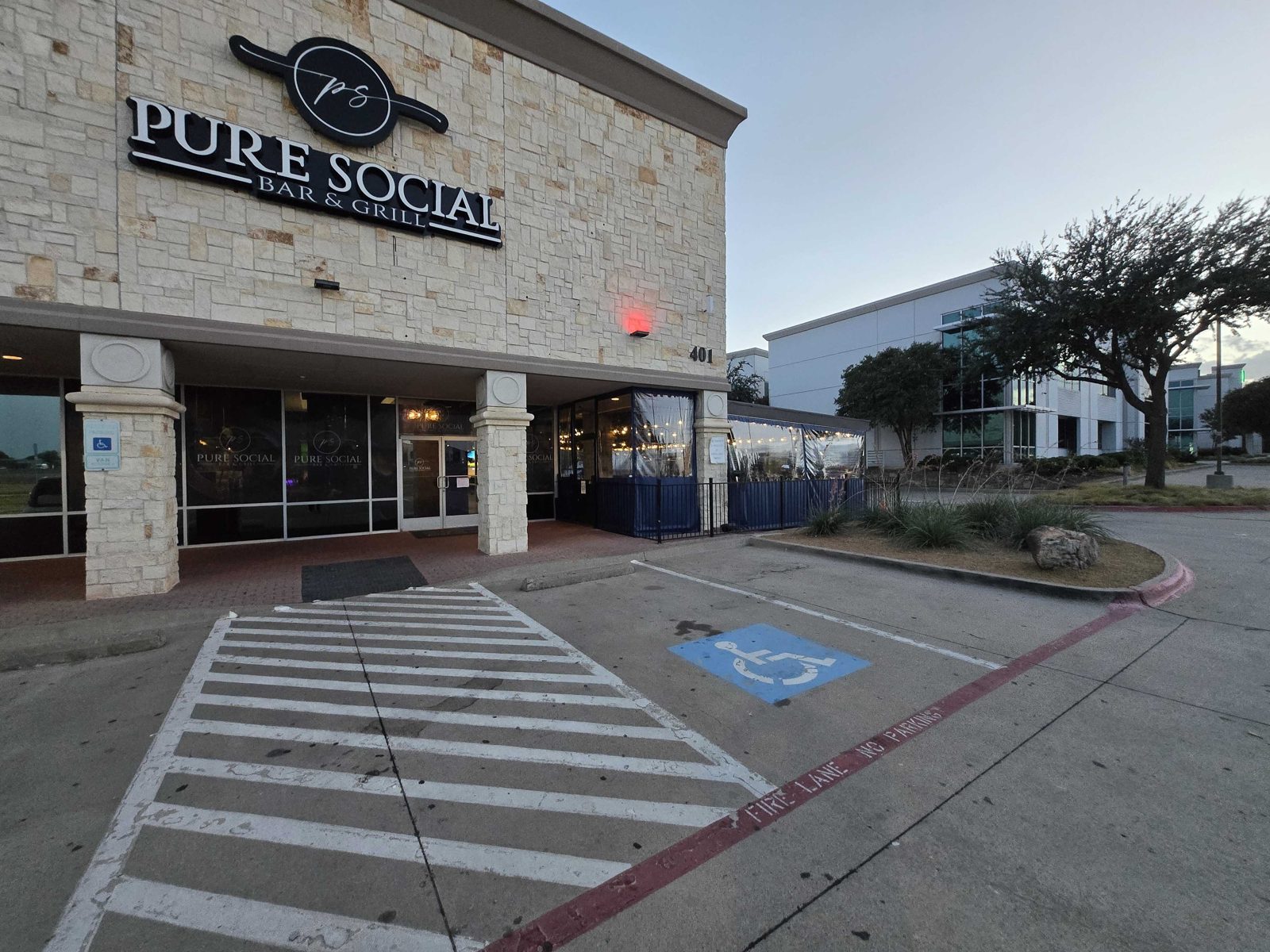 The entry side of Pure Social with the enclosed patio beyond the columns