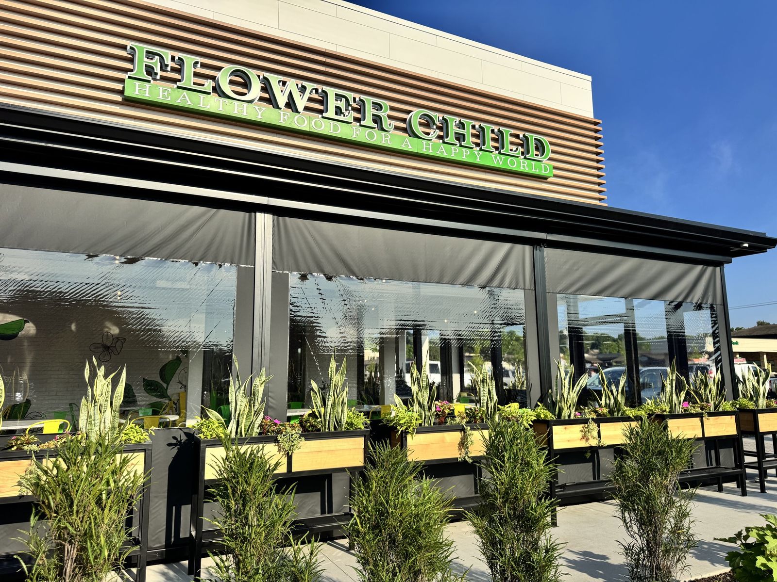 Flower Child, Prairie Village, Kansas: a motorized clear vinyl enclosure along the full patio front