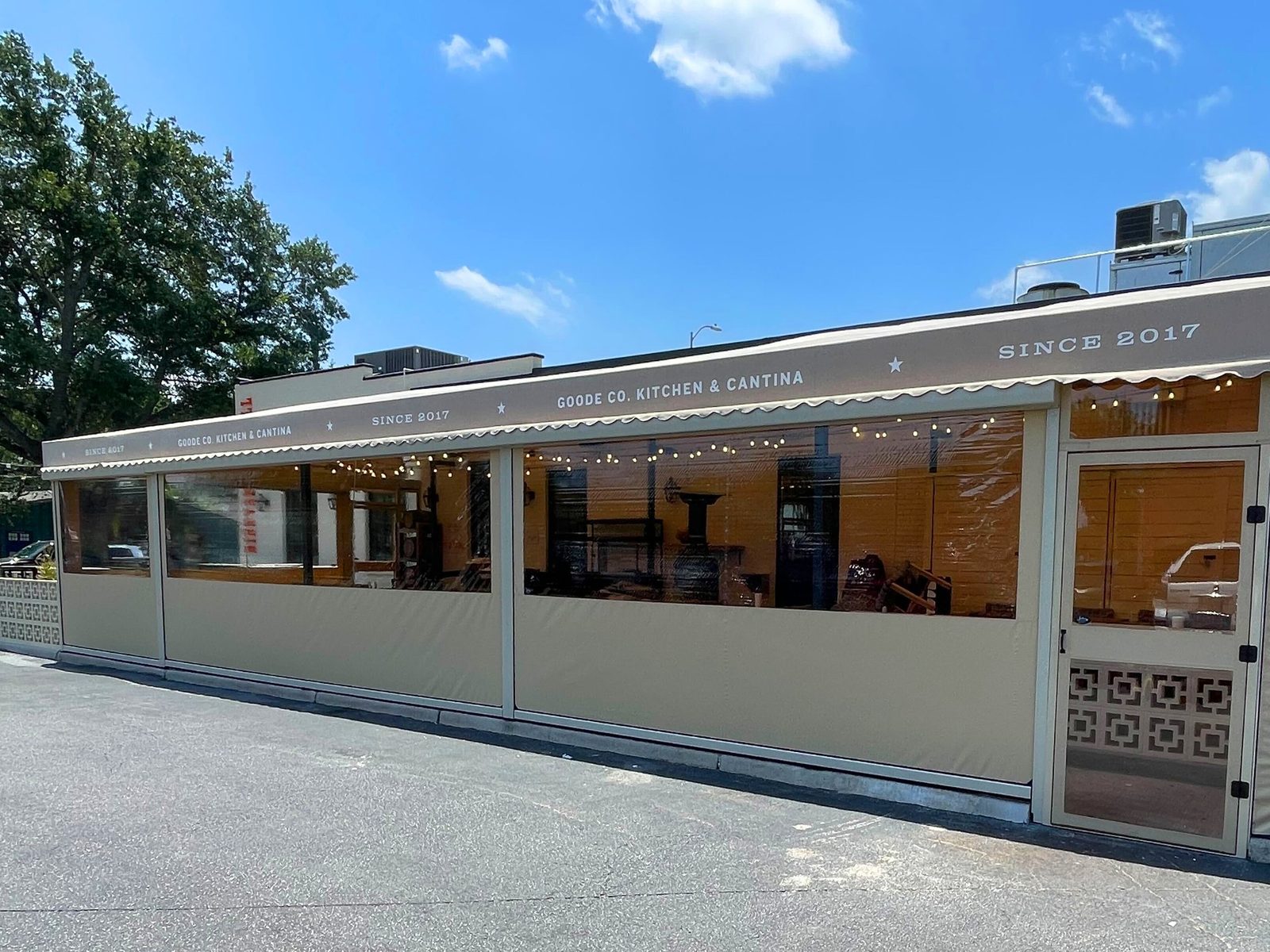 Goode Co. Kitchen & Cantina, Houston, Texas: patio enclosed with motorized tan panels and clear windows