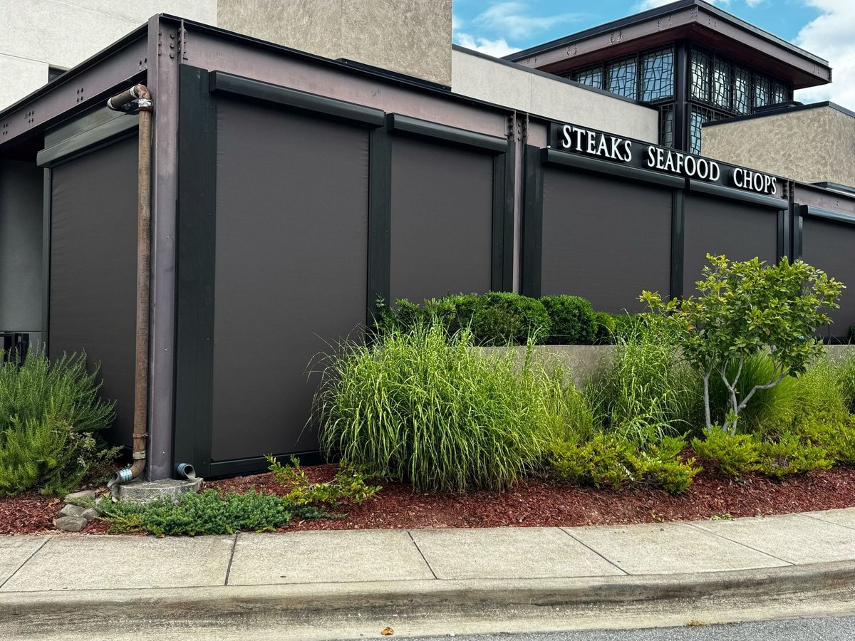 Perry's Steakhouse & Grille, Birmingham AL — motorized sun shades closing in the patio as a windscreen