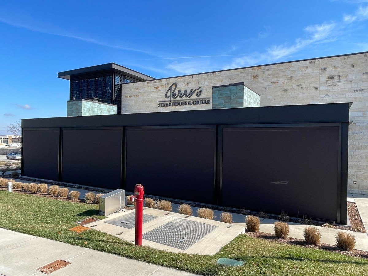 Perry's Steakhouse & Grille — motorized sun shades down around the patio