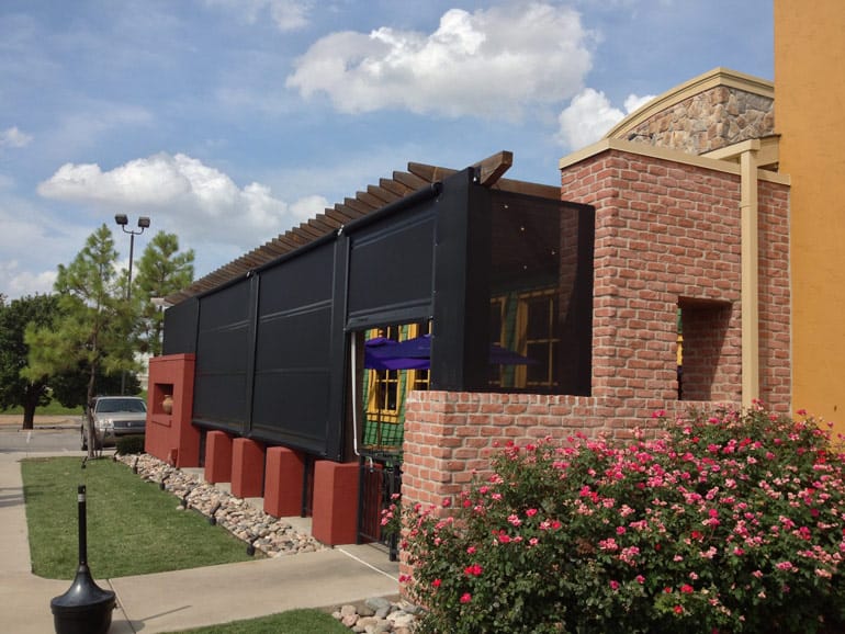 custom built motorized sun shades restaurant sunroom exterior summer day