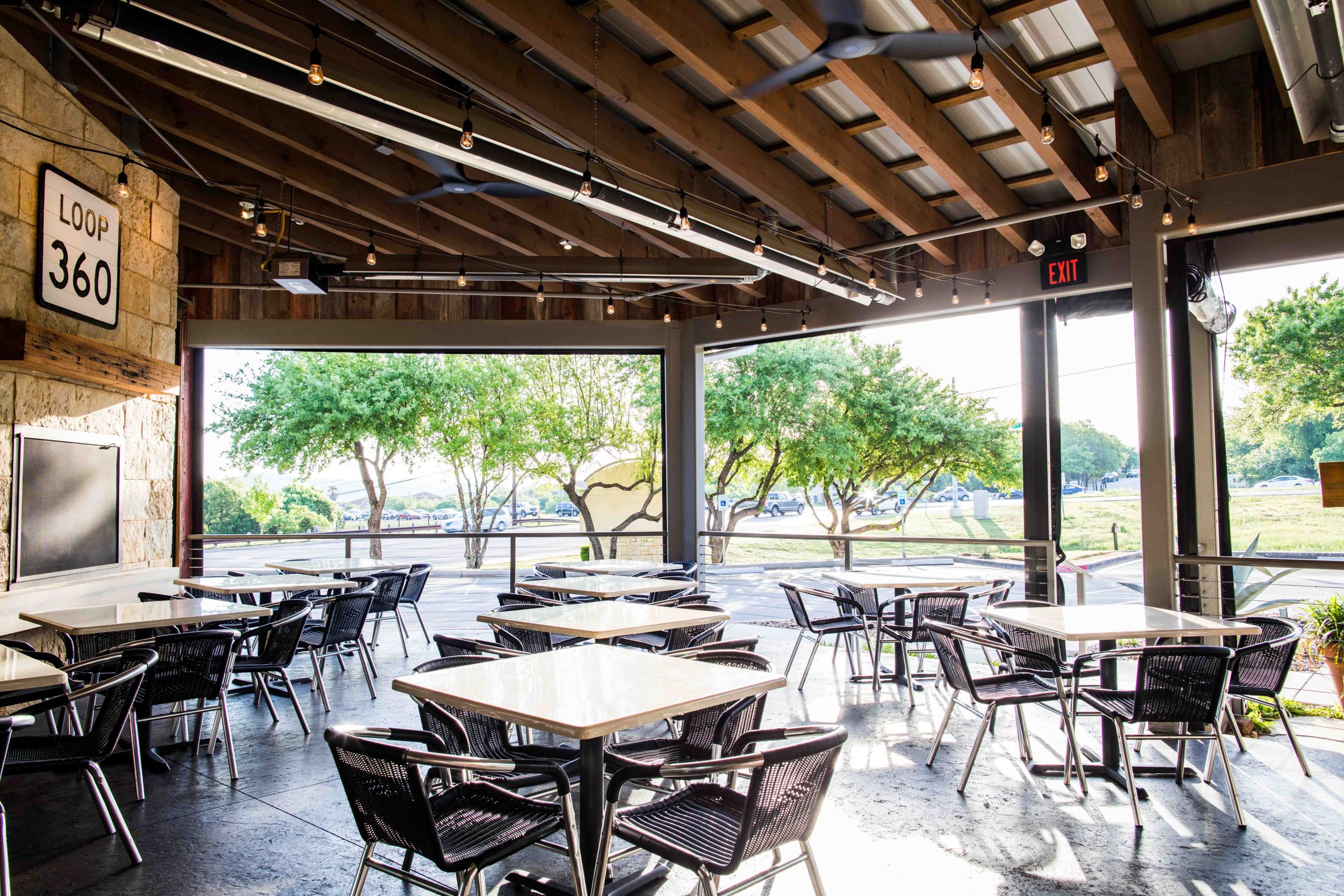 jack allens patio area austin texas black restaurant tables and chairs sunny day