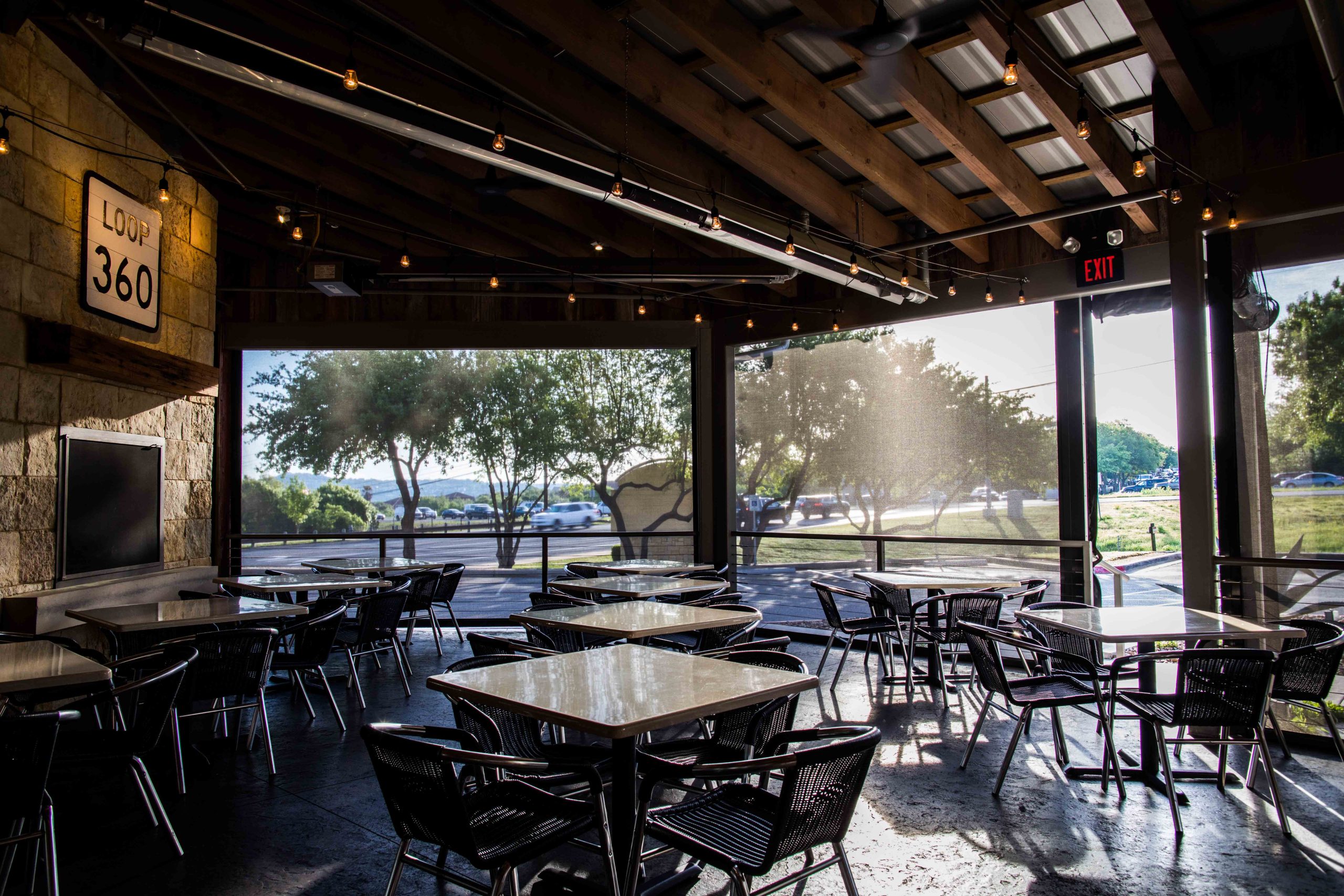 restaurant motorized sun shades lowered jack allens patio austin texas