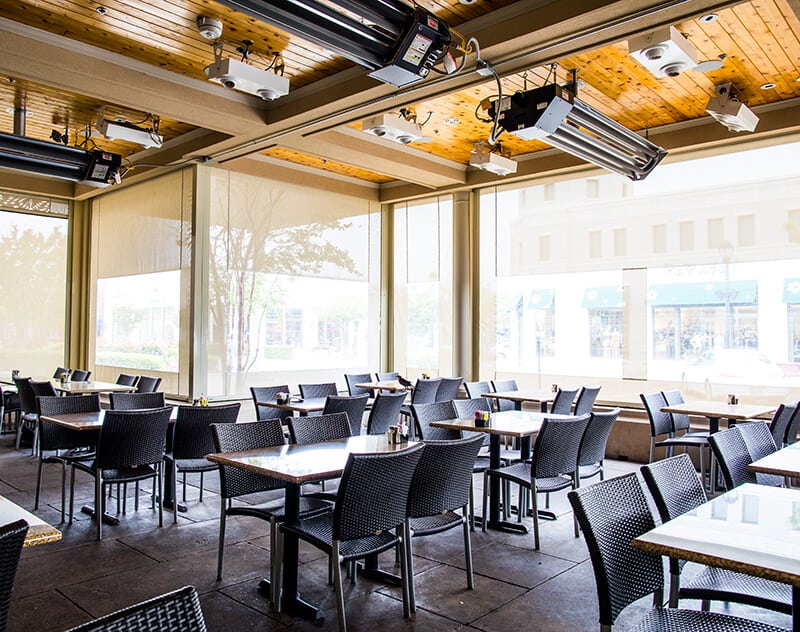 custom beige patio sun shades with clear vinyl windows and climate control system deployed glorias interior patio garland texas restaurant furniture