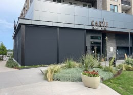 Carve American Grille Austin – Motorized Sun Shades and Bug Screens Motorized sun shades and bug screens installed at Carve American Grille in Austin, Texas by Southern Patio Enclosures – Nano 97 black fabric with hoods, side tracks, and weight bar