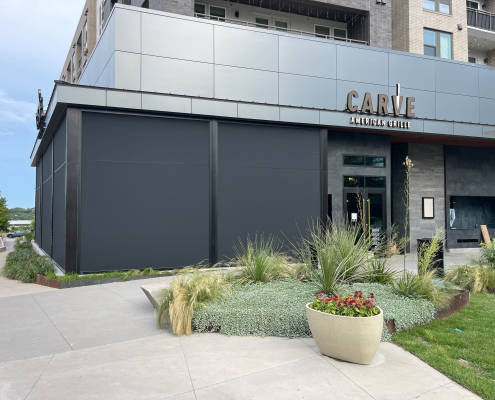 Carve American Grille Austin – Motorized Sun Shades and Bug Screens Motorized sun shades and bug screens installed at Carve American Grille in Austin, Texas by Southern Patio Enclosures – Nano 97 black fabric with hoods, side tracks, and weight bar