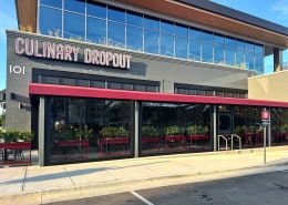 Culinary Dropout Franklin – Exterior View of MaxView Motorized Clear Patio Enclosures Exterior street view of MaxView motorized clear patio enclosures at Culinary Dropout in Franklin, Texas by Southern Patio Enclosures – showing full clear vinyl panels, egress door, and how the enclosures blend with the modern restaurant facade while maintaining an open feel